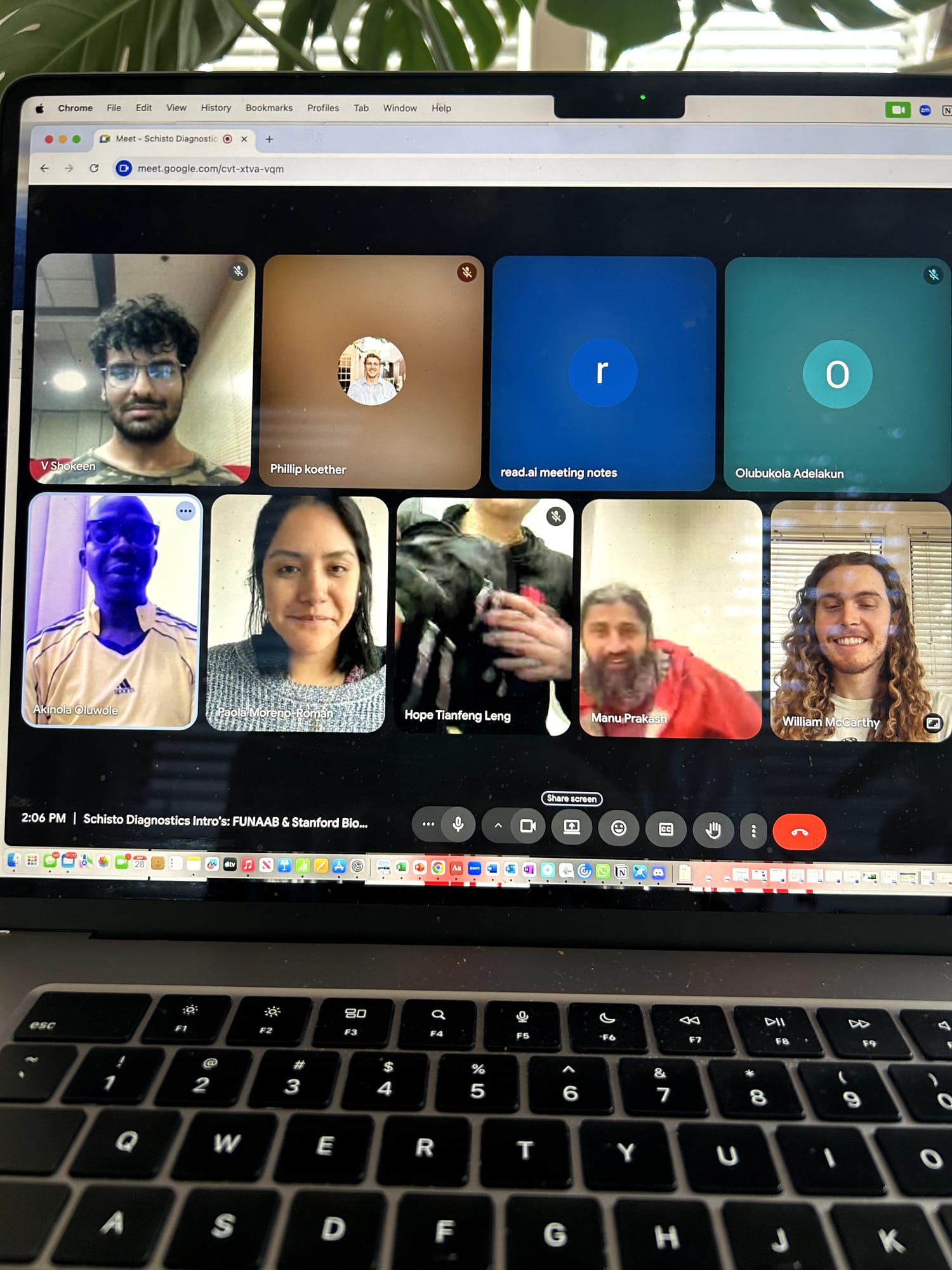 A laptop screen showing a video call grid of team members and mentors